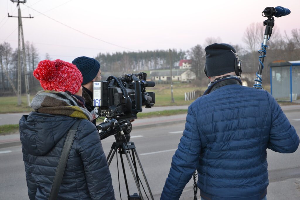 tv crew filming by road